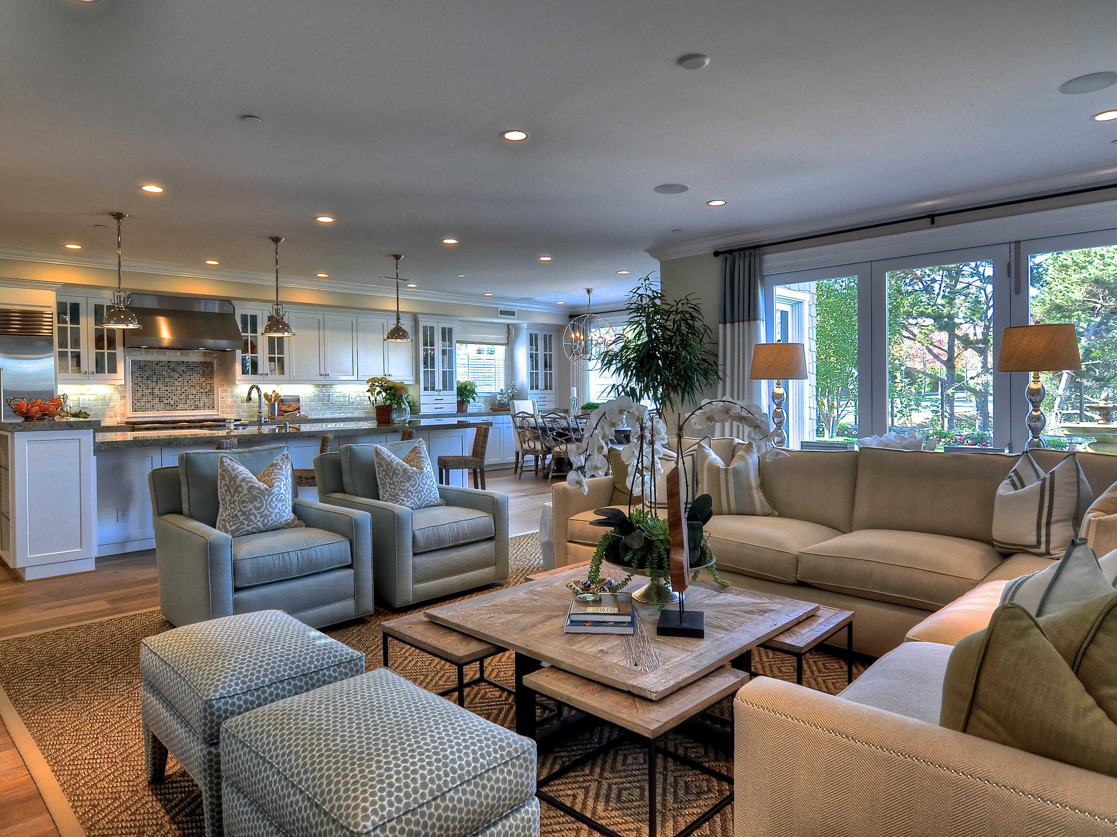 Open living room with beige sectional sofas and patterned ottomans bathed in soft afternoon light; warm earth tones with a vintage analog film grain and a calm, motivational atmosphere